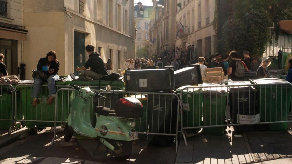 French high school students gather outside the Lycee Sophie Germain high school
