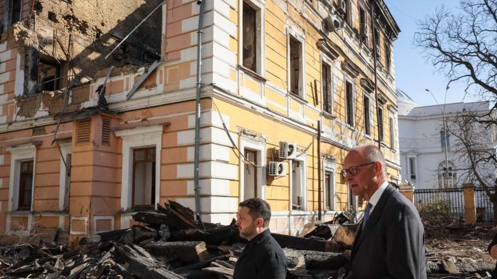 Ukrainian President Volodymyr Zelensky (left) and German Chancellor Friedrich Merz visit the main building of Ukraine's National Academy of Sciences in Kyiv that was badly damaged by a Russian drone strike earlier this week. Photo: 4 October 2026