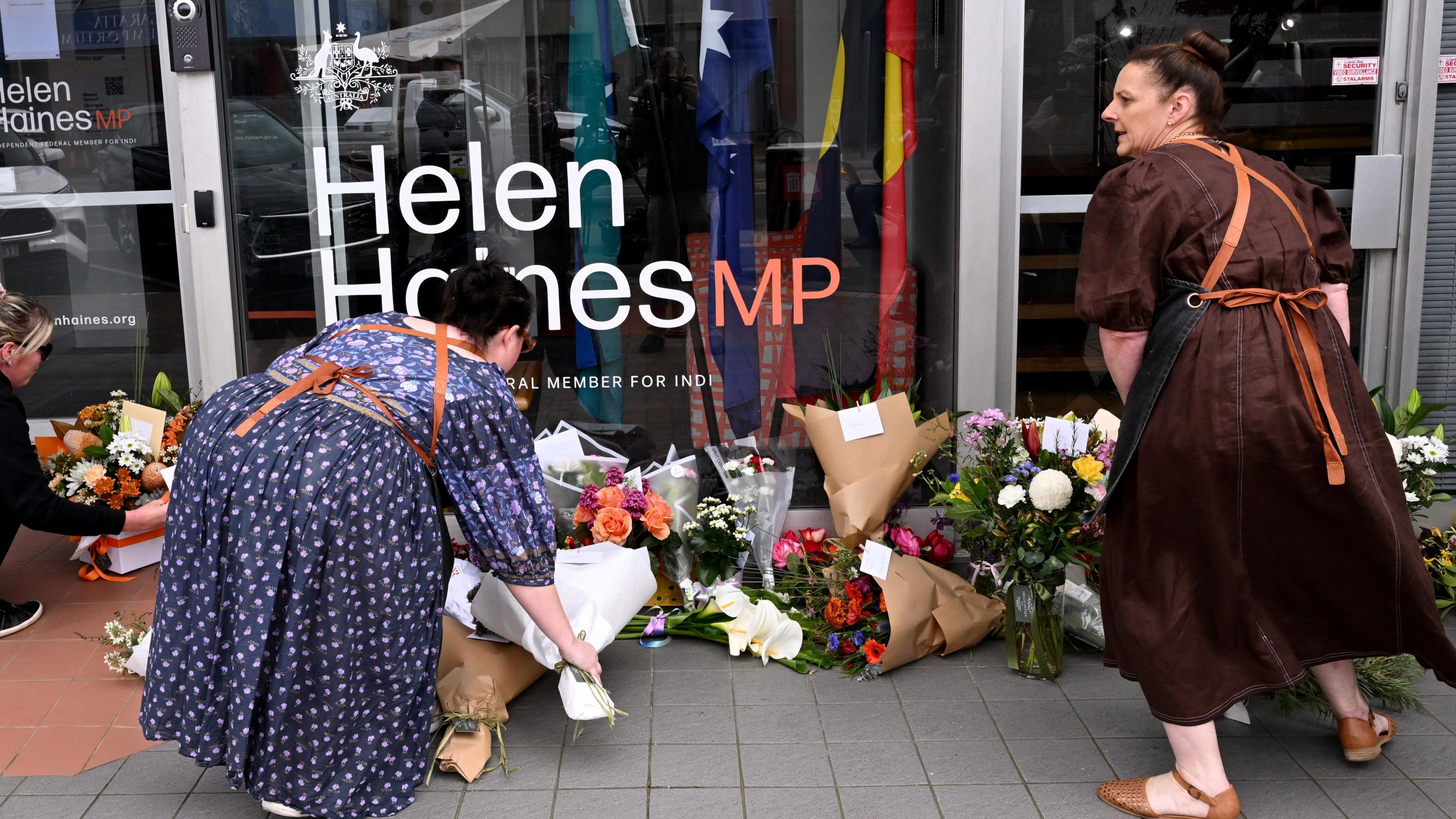 Women leaving flowers outside Helen Haines's office