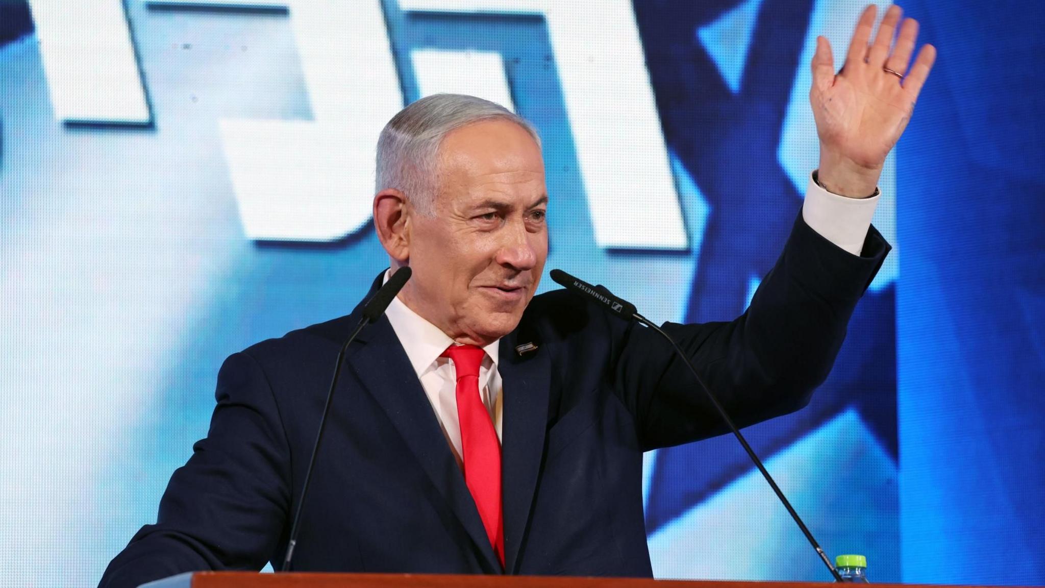 Israeli Prime Minister Benjamin Netanyahu waves while addressing supporters at his Likud party's headquarters in Jerusalem (28 October 2026)