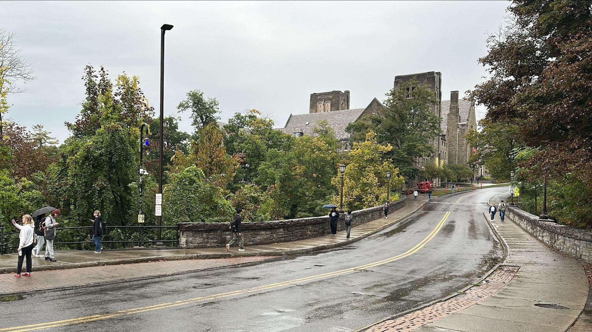 A long road towards the Cornell University campus is seen on a rainy day