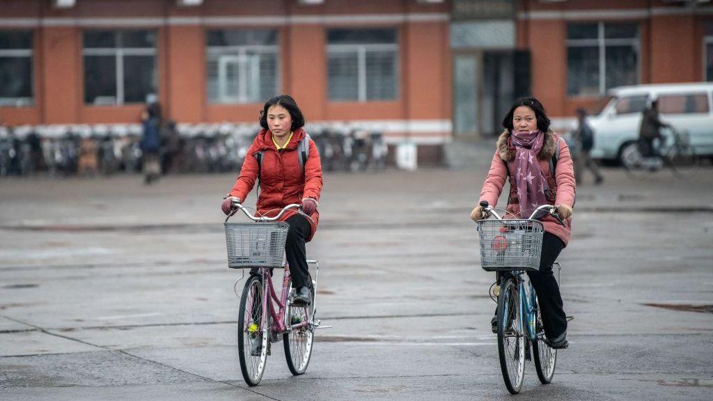 North Korean women cycle across Hamhung Square on February 03, 2019 in Hamhung, North Korea.