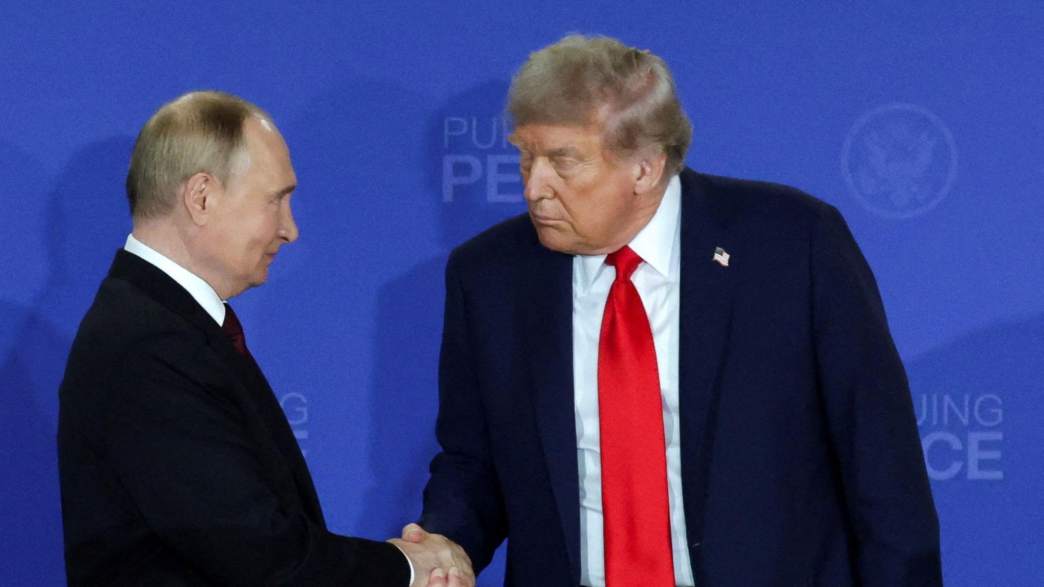 U.S. President Donald Trump and Russian President Vladimir Putin shake hands during a press conference