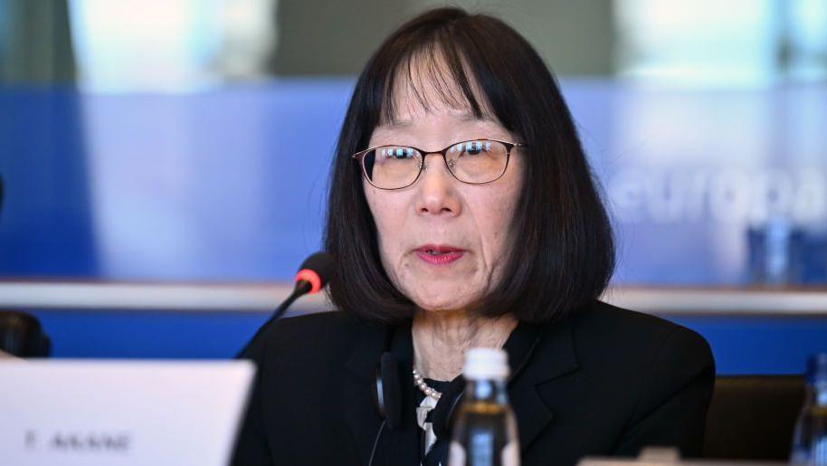 Judge Tomoko Akane at the microphone at an event in Brussels
